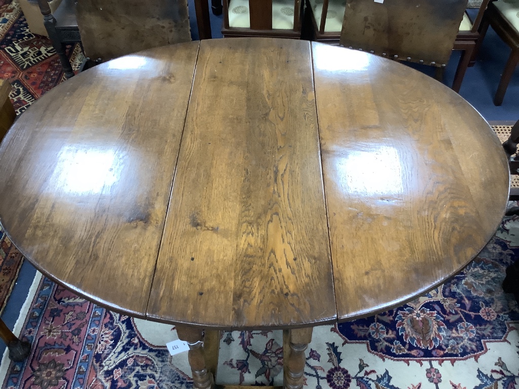 An 18th century style oval oak gateleg dining table, length 150cm extended, width 122cm, height 75cm